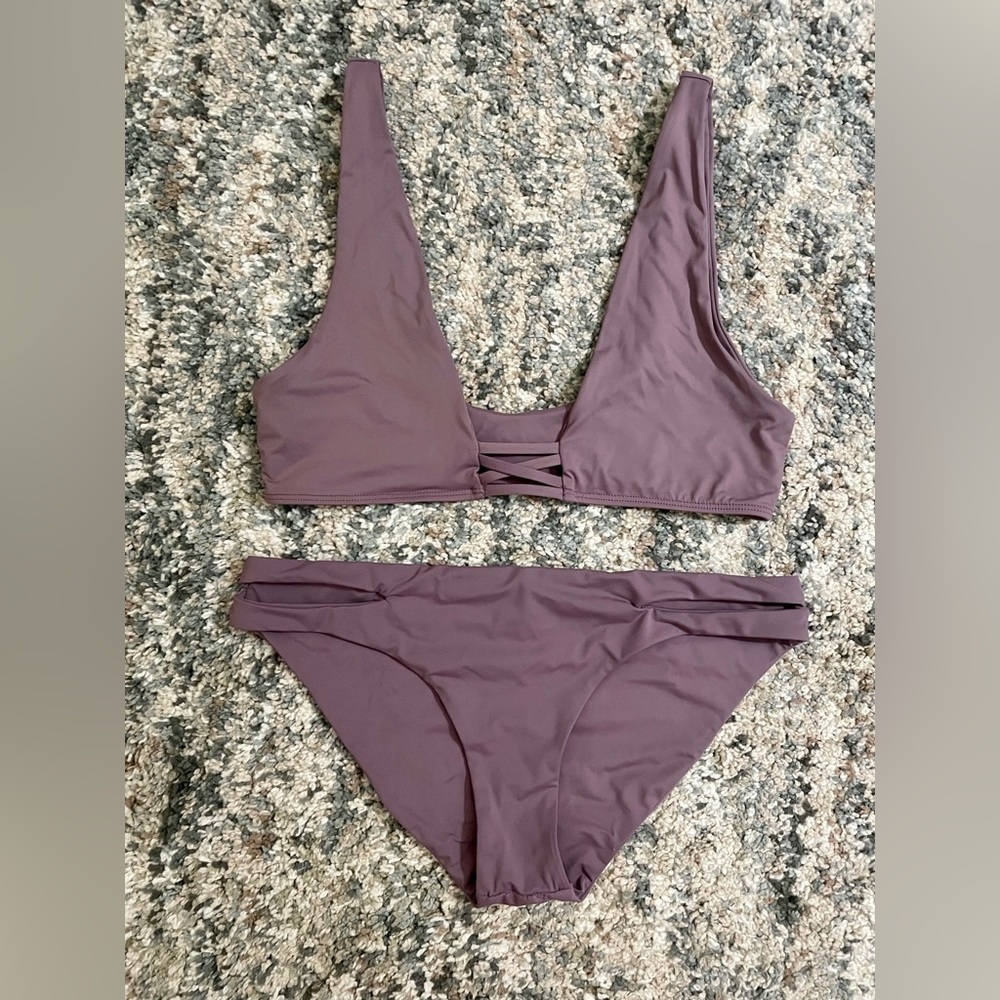 Dippin Daisy’s bikini- top is small and bottoms are medium. Lavender color.